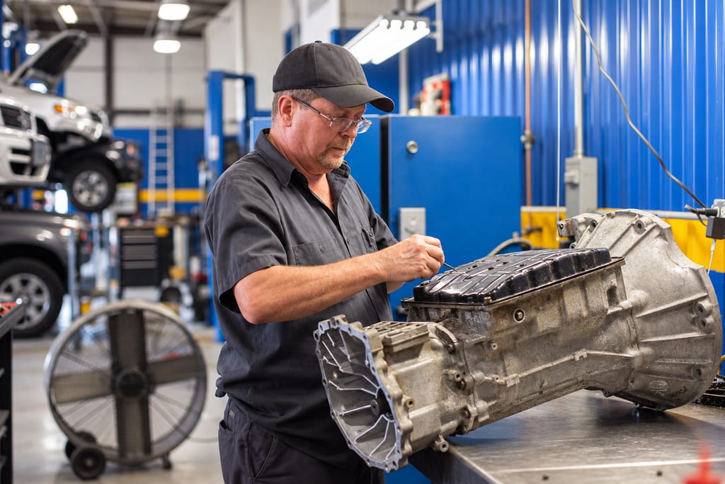 Technician working on an automatic transmission on the bench at Hi-Tech Transmissions